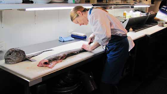 Chef Kelly Myers, of Xico, prepares a Wolf Eel for the upcoming dinner