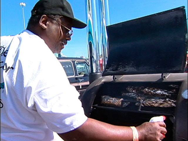 Inside The World of Championship Barbecue - Hayward Harris Jr tending his cooker