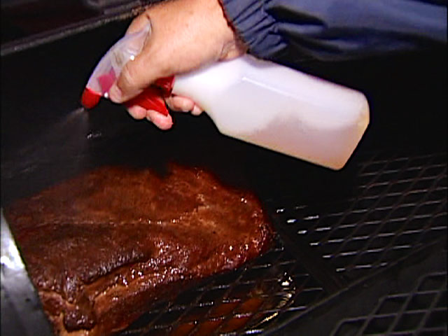 Inside The World of Championship Barbecue -Spraying apple Juice on a Pork Roast